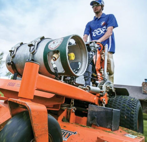 man-on-propane-lawnmower